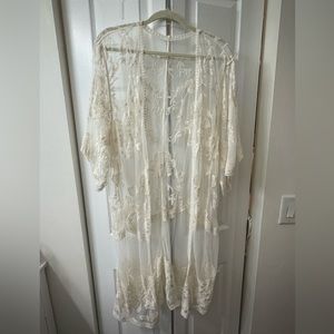 Lace open long jacket/cover up. No size tag. Under arm to under arm 27 inches.